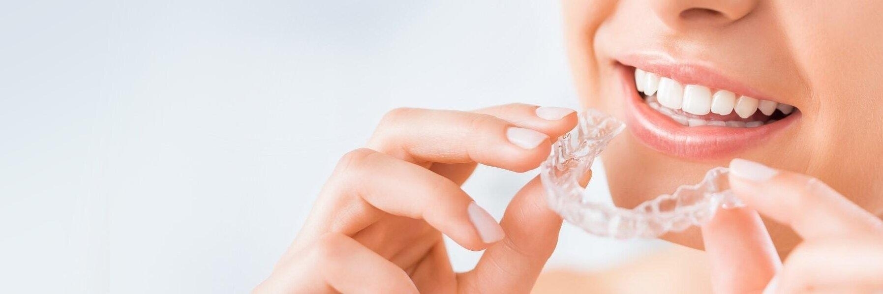 woman holding invisalign aligners in bondi junction