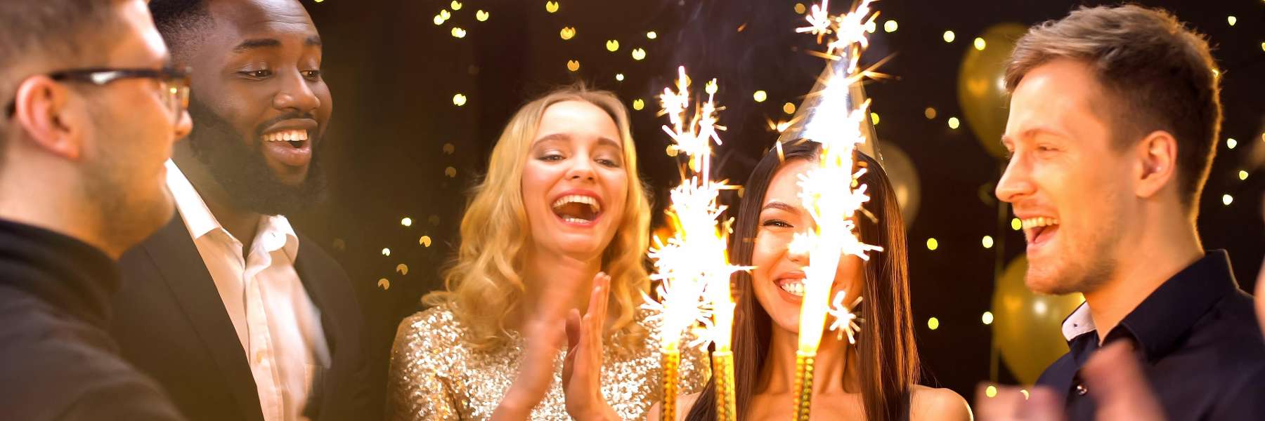 group of friends celebrating a birthday with sparkler candles