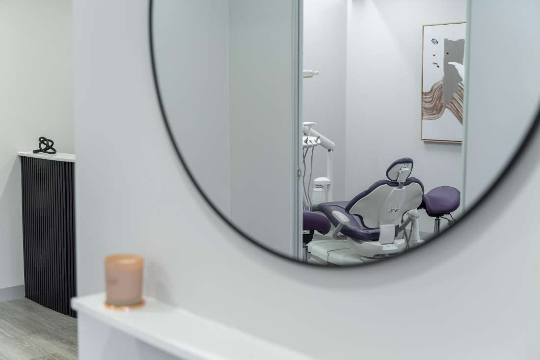mirror showing a dental chair in the reflection 